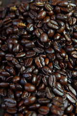 Spilled, roasted coffee beans. Coffee beans close up