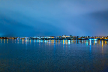 Obraz premium Night photo of Reykjavik city beach. Waterfront lights