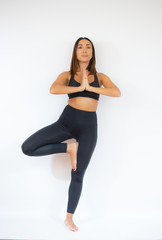 Fototapeta na wymiar Beautiful woman in sport clothes doing yoga exercises