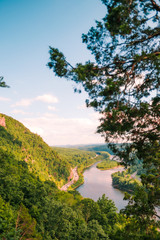 Mountain Range with River flowing in between and Blue Sky in background