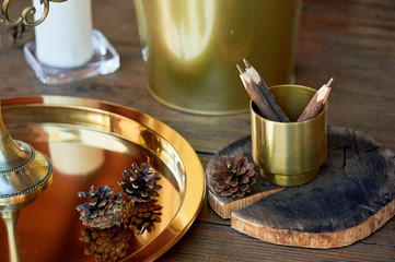 Pencils in a gold cup holder.Made like a stick of wood. Eco pens. Interesting and unusual office.
