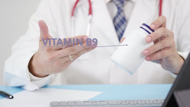 VITAMIN B9, a generic supplement, in the bottle in doctor's hand