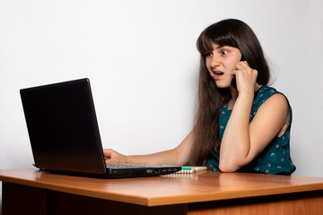 A businesswoman is a freelancer talking on the phone and writhing a disgruntled grimace. A banner with a place for text.