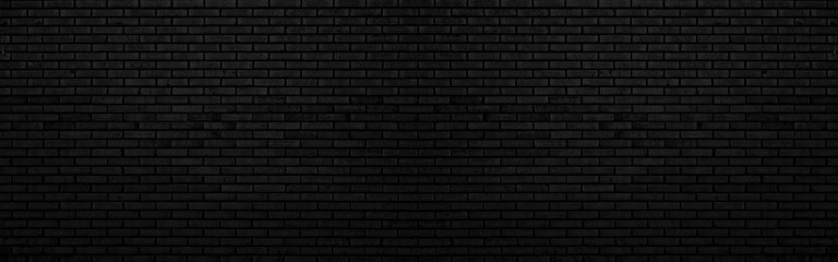 Abstract black brick wall texture for background or wallpaper design. panorama picture.