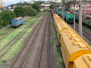 Freight train on the railway. Train carriages on the railway track. Closed wagons of a freight...