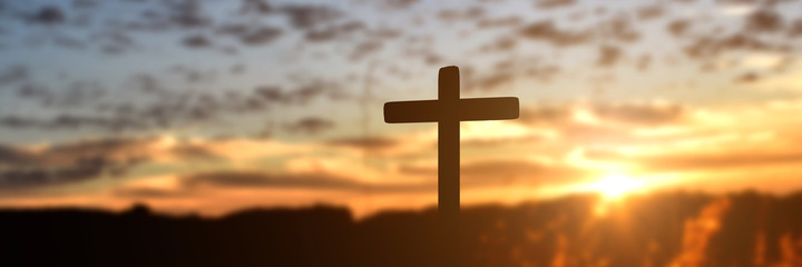 Silhouette of catholic cross at sunset background. panorama picture