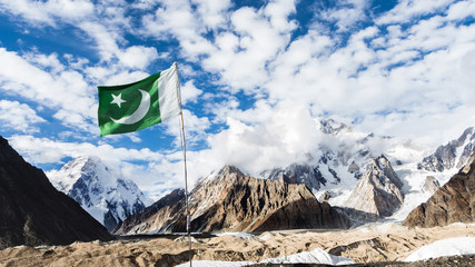 Pakistan flag on Concordia, Baltoro glacier, with K2 and Broad Peak mountains in the background, Karakoram, Pakistan