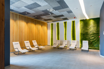 Sunbeds in green relaxing room in wellness center