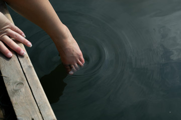 Woman's foot dipping into water