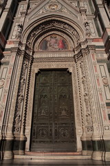 View of the Sculpture and painting on the door of Florence Duomo in Florence Italy