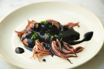 Chipirones, typical calamari from spain served with its ink