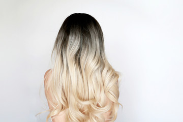 Naked woman with long blonde hair, back view. Female beauty and hairstyle
