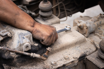 clossup the dirty hands of a auto mechanic is working