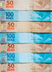 Brazilian money background. Brazilian Real banknotes. Economy concept. Vertical photo.
