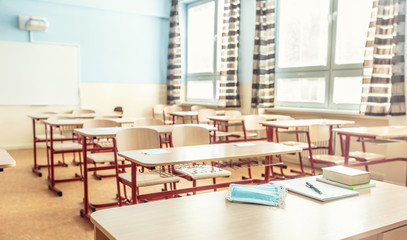 Face mask on a teachers and school desk in a school classroom