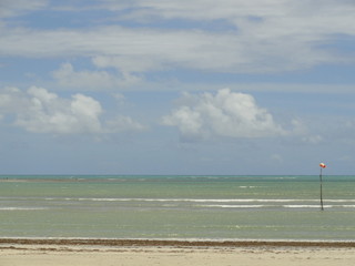 Fototapeta na wymiar beach and sea waves with blue sky
