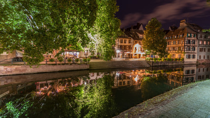 Fototapeta na wymiar The water Reflection at night in the little France in Strasbourg in France