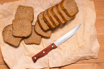 Assortment of baked bread on wooden table background