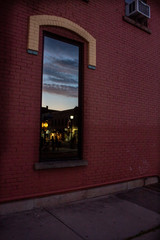 Main Street Wellsville NY reflected in a window at sunset