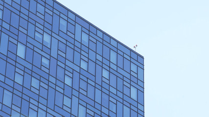 Obraz premium Modern high-rise office building with a glass facade. Modern Business Office Buildings with Glass Windows. Skyscraper building, business architecture