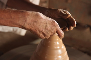 Potter man, clay molding, shaping clay molding potter, potter hand clay mold