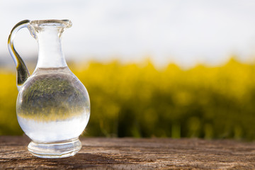 Oil glass jar and mustard seeds with flower