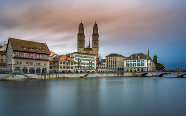 Fototapeta premium Grossmünster Cathedral in Zürich, Switzerland. Long Exposure of the Grossmünster Cathedral and old town from Limmat river.