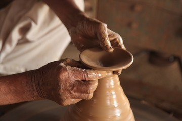 Potter man, clay molding, shaping clay molding potter, potter hand clay mold