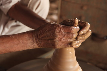 Potter man, clay molding, shaping clay molding potter, potter hand clay mold