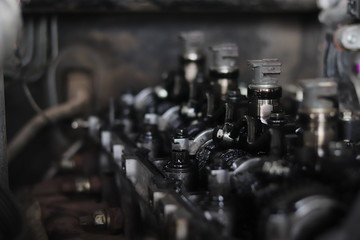 The mechanic is checking the engine.