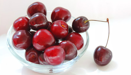 raw fresh cherries in a transparent bowl