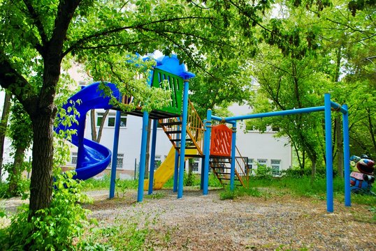 Empty Colorful Playground Park With Big Trees And Thick Weeds With No Kids Due To Covid-19.  Cayyolu Ankara Turkey