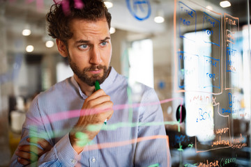 Programmer working and developing software in office