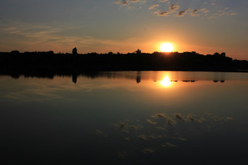 Summer landscape with the sun setting over the river. Sunset background