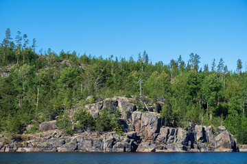 A sense of complete freedom. Amazing view of the nature of Karelia with skerries, fjords and mountains. Beautiful reflection. Ladoga skerries, Scandinavian landscape, Russia. World of beauty.