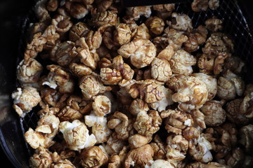 warm popcorn coated by caramel and chocolate in the black deep air fryer electric pot 