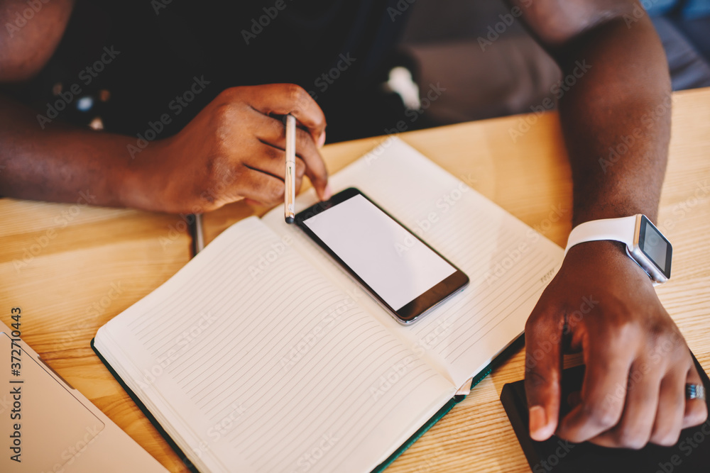 Poster cropped image of male using telephone with mock up screen for sending text messages, desktop with no