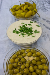 Popular Israeli snacks - spicy pickled pepper, sesame paste - tahini and green olives