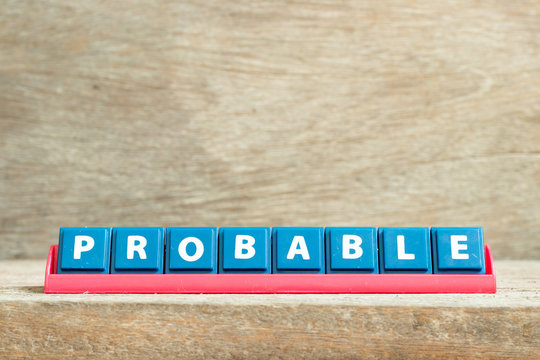 Tile letter on red rack in word probable on wood background