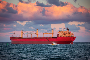 Cargo ship with containers in sunset light