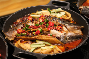 close up roasted fish with peppers in pot. Chinese cuisine
