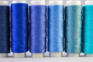 An assortment of blue sewing threads