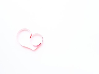 The heart is made of red paper on a white background. Valentine's Day.