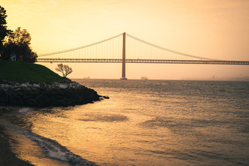 Sunset over the Ponte 25 de Abril, Lisbon, from Almada riverside.