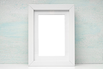 White frame for photos and drawings on a colored background. Interior Design. Mock up.