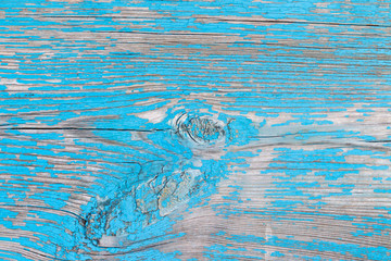 Old weathered wooden background with cracked blue paint