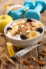 muesli breafast with cereal, fruits and fitness accessories