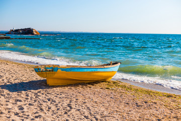 Beautiful seascape view with an old boat on the blue sea tropical beach in sunny day