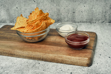 Corn cheese, snacks with sauce on a wooden stand. Beer snack, dish on the menu. Close up.