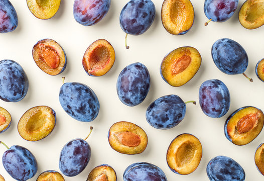 blue plums on beige white background